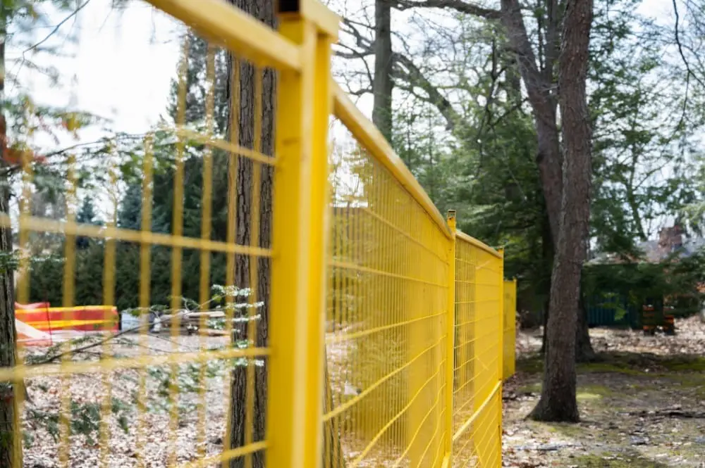 yellow temporary fence rentals set up on a construction site