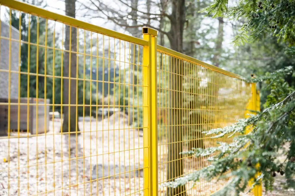 yellow temporary fence rentals set up on a construction site