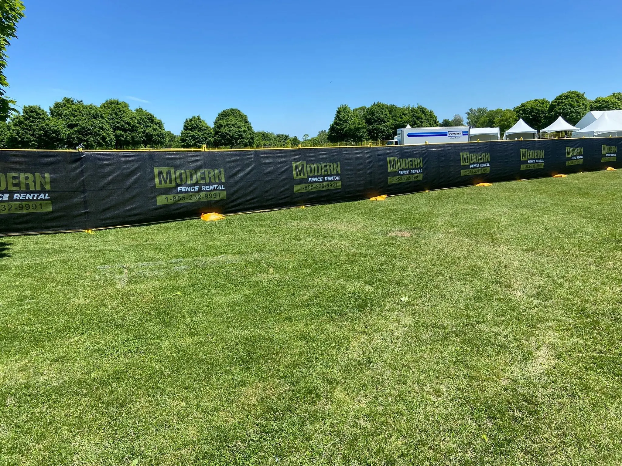 yellow temporary fence rentals set up on a construction site