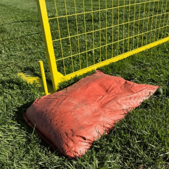 Modern Fence Rental - Temporary Fence Rental Accessories - Sandbag sandbag on top of a temporary fence base