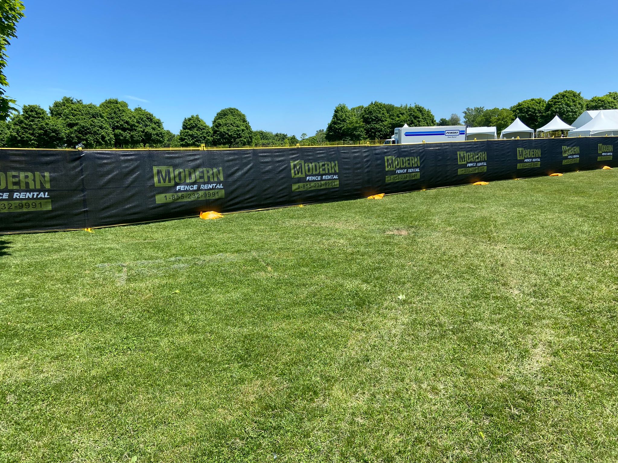 yellow temporary fence rentals set up on a construction site